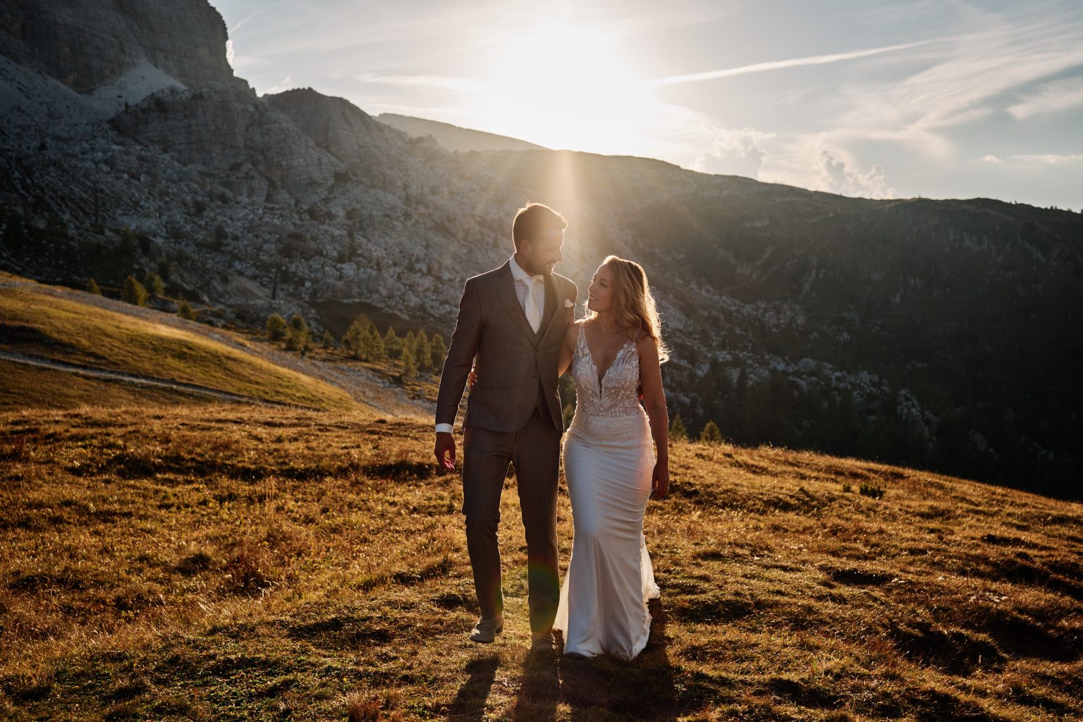 The couple in the evening light on the grass, Dolomites wedding