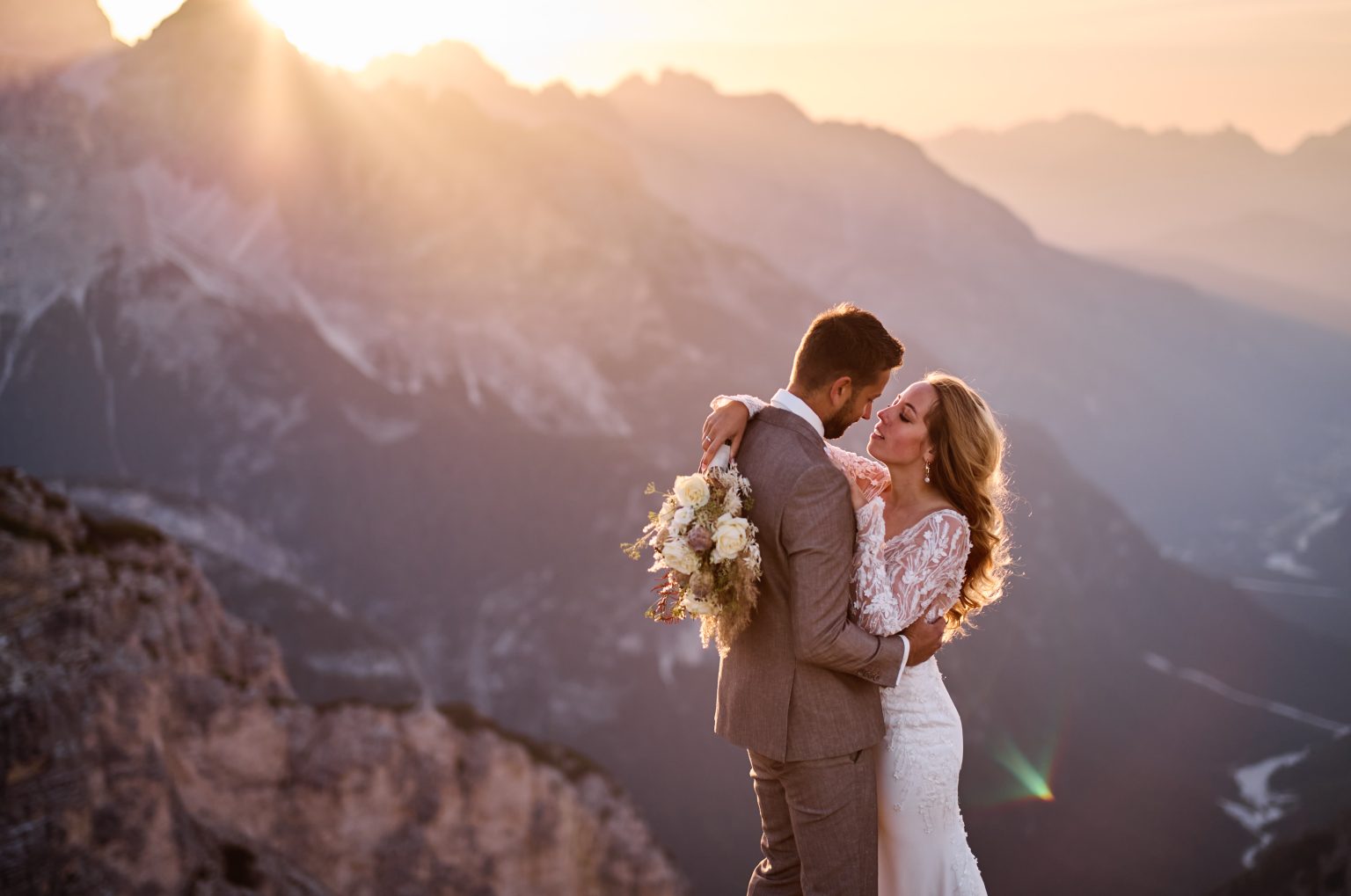 Couple embracing in golden light, Tre Cime di Lavaredo wedding
