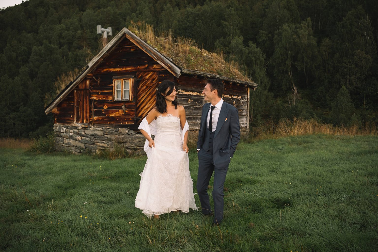 Ida and James by an old farm cabin at sunrise, Norway