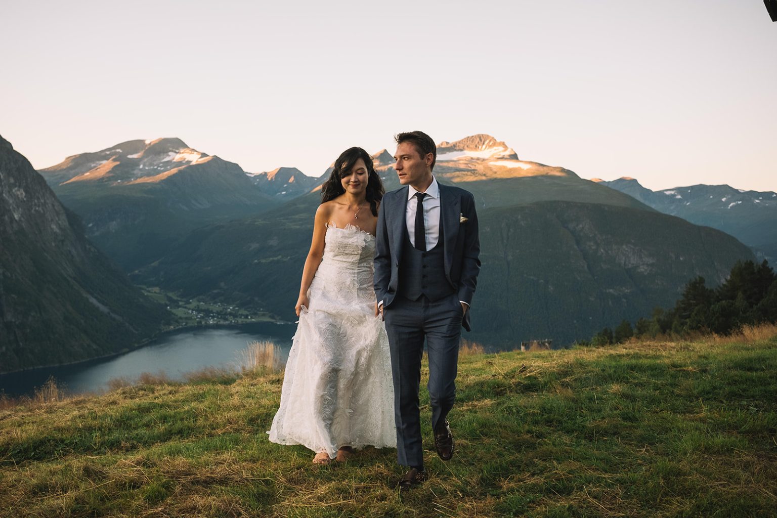 Walking above the fjord with snowcapped peaks at dawn, a Juvet wedding