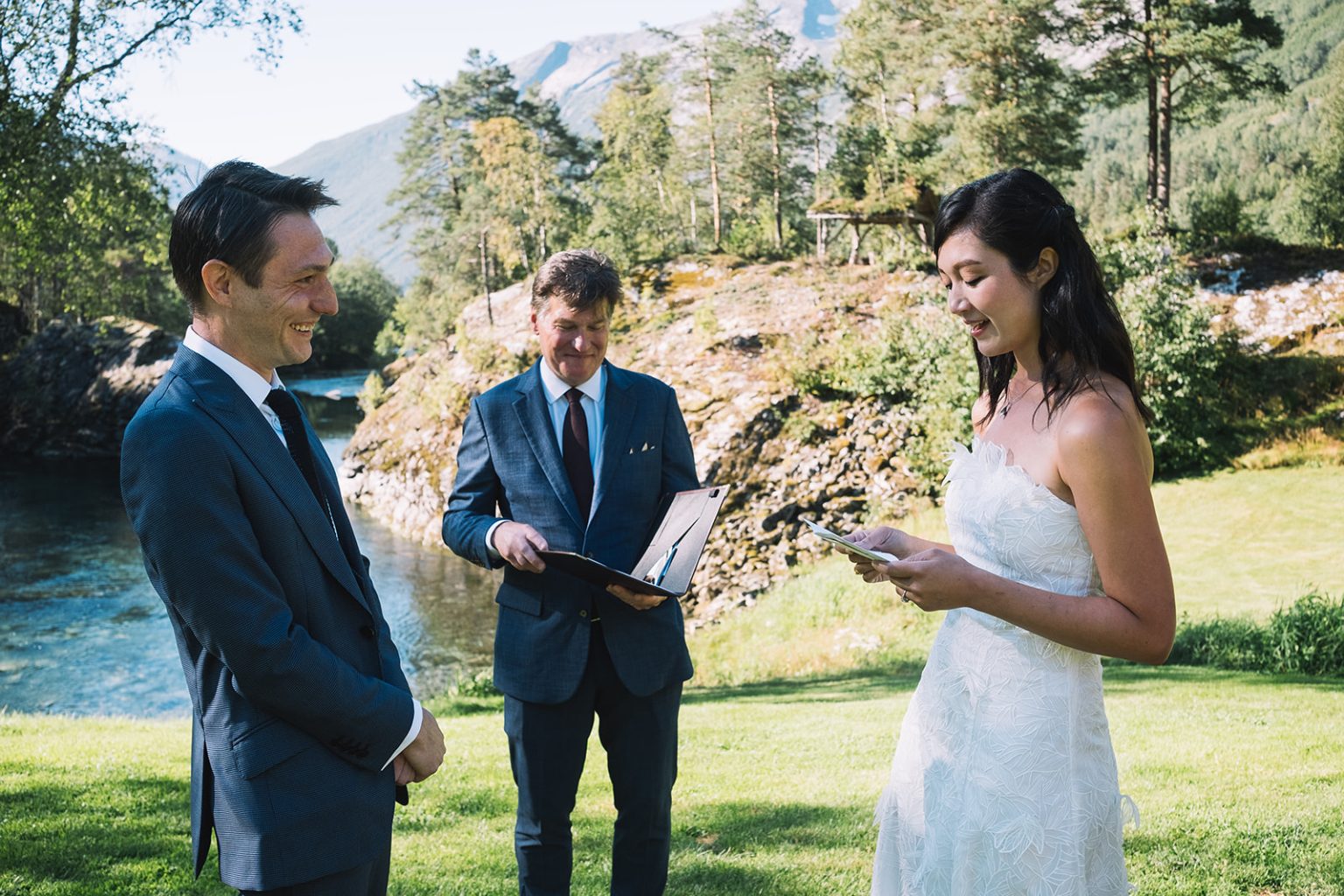 Exchanging vows by the river at Juvet, Norway wedding