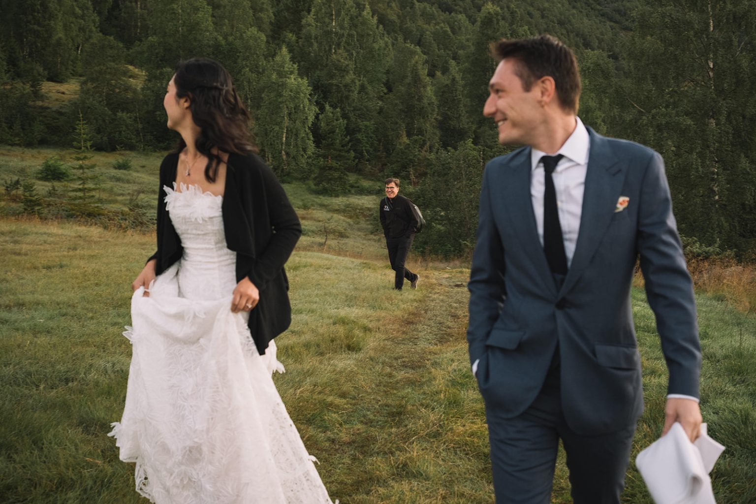 Ida and James walking the hillside at dawn, a Juvet wedding photographer