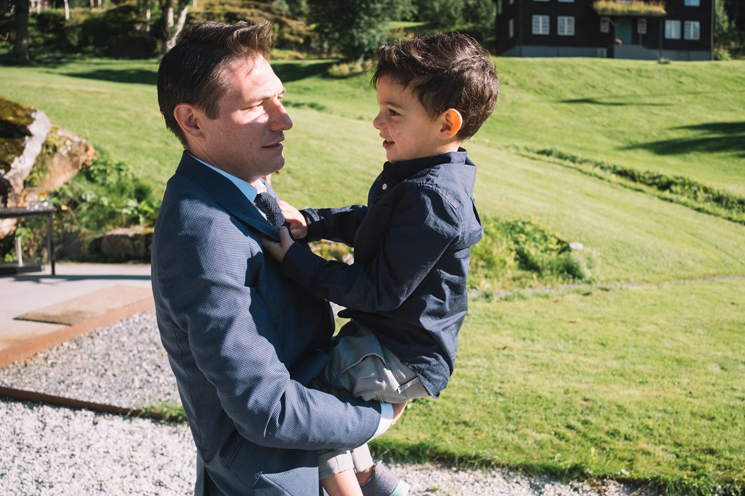A guest lifting a child at the reception, Juvet Landscape Hotel