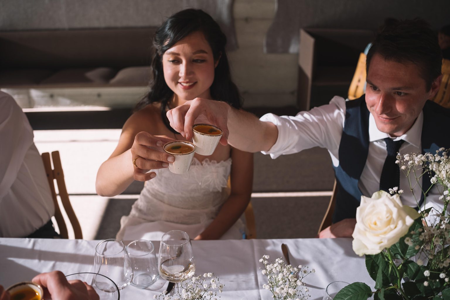 Ida and James laughing at dinner, a Juvet wedding photographer
