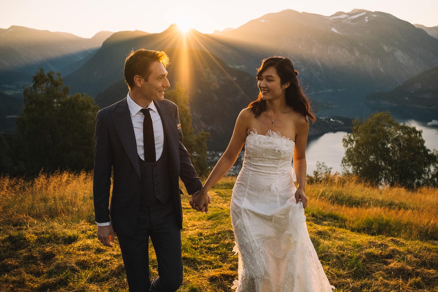 Walking hand in hand into the sunrise over the fjord, Juvet wedding