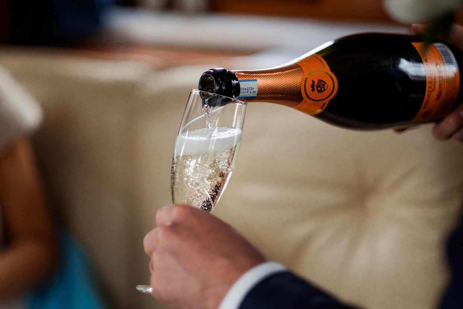Champagne poured aboard the boat, Norway fjord wedding