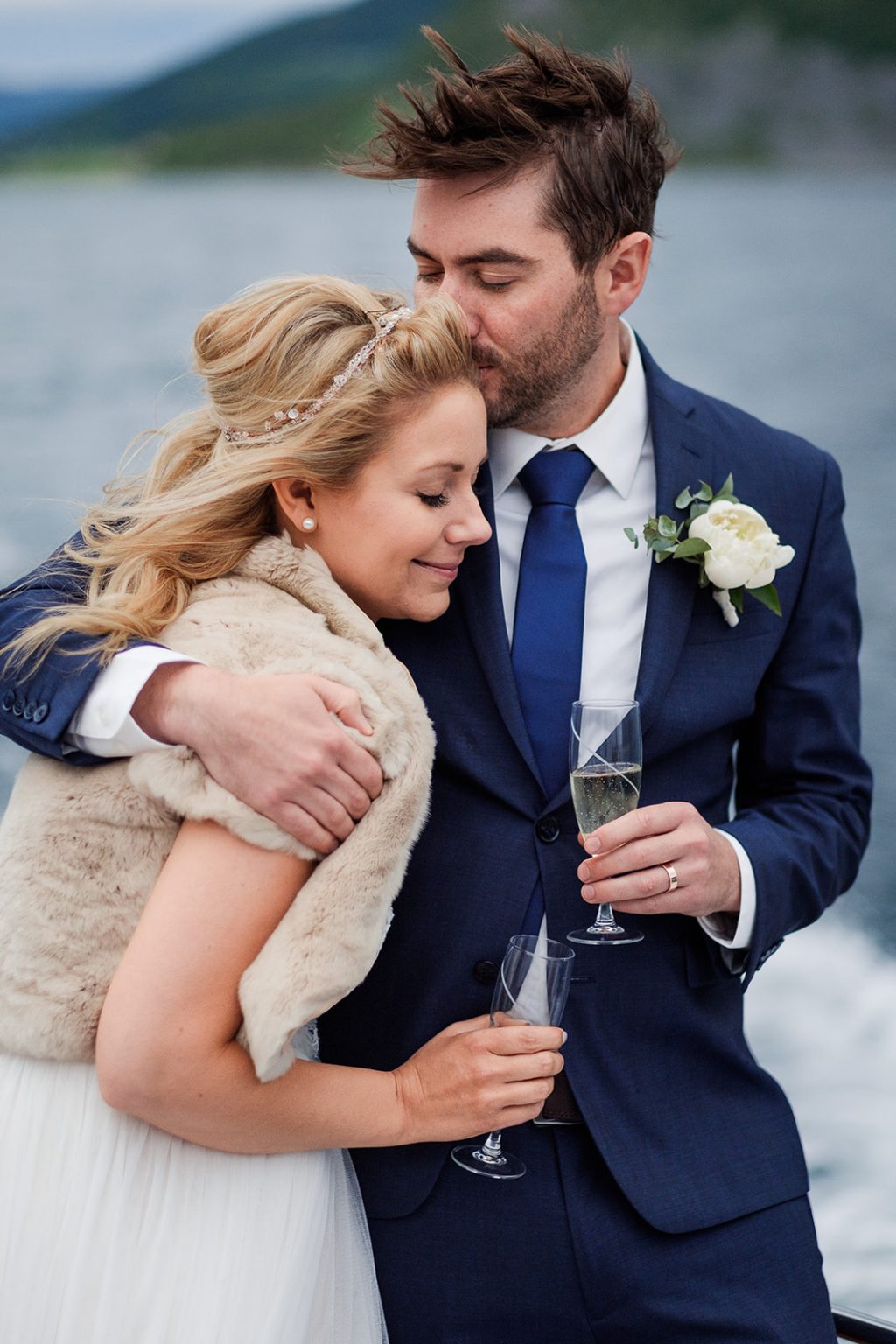 Bride and groom embracing on the boat, black and white