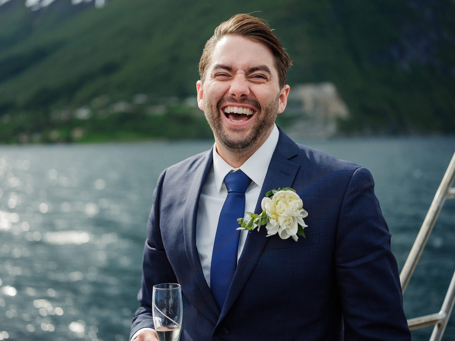The groom on deck as the boat crosses the fjord