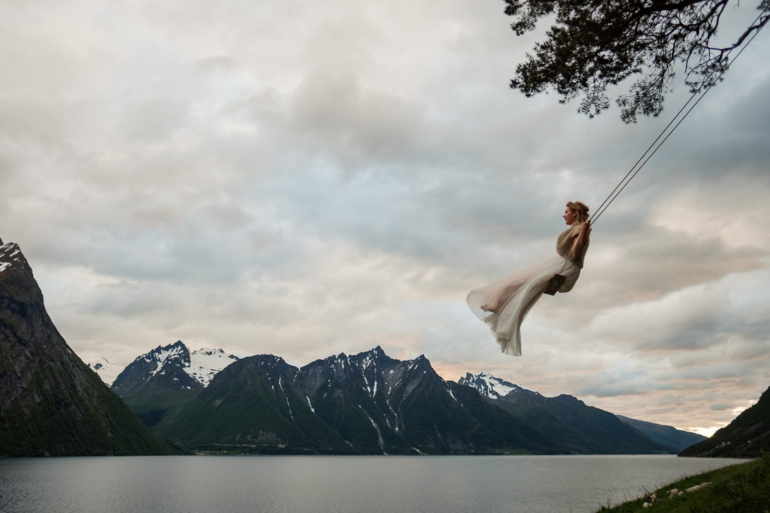 Bride on a swing out over the fjord at Øye