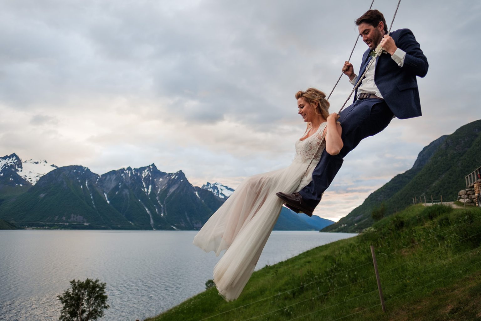 Bride and groom on the swing over the fjord, Hotel Union Øye