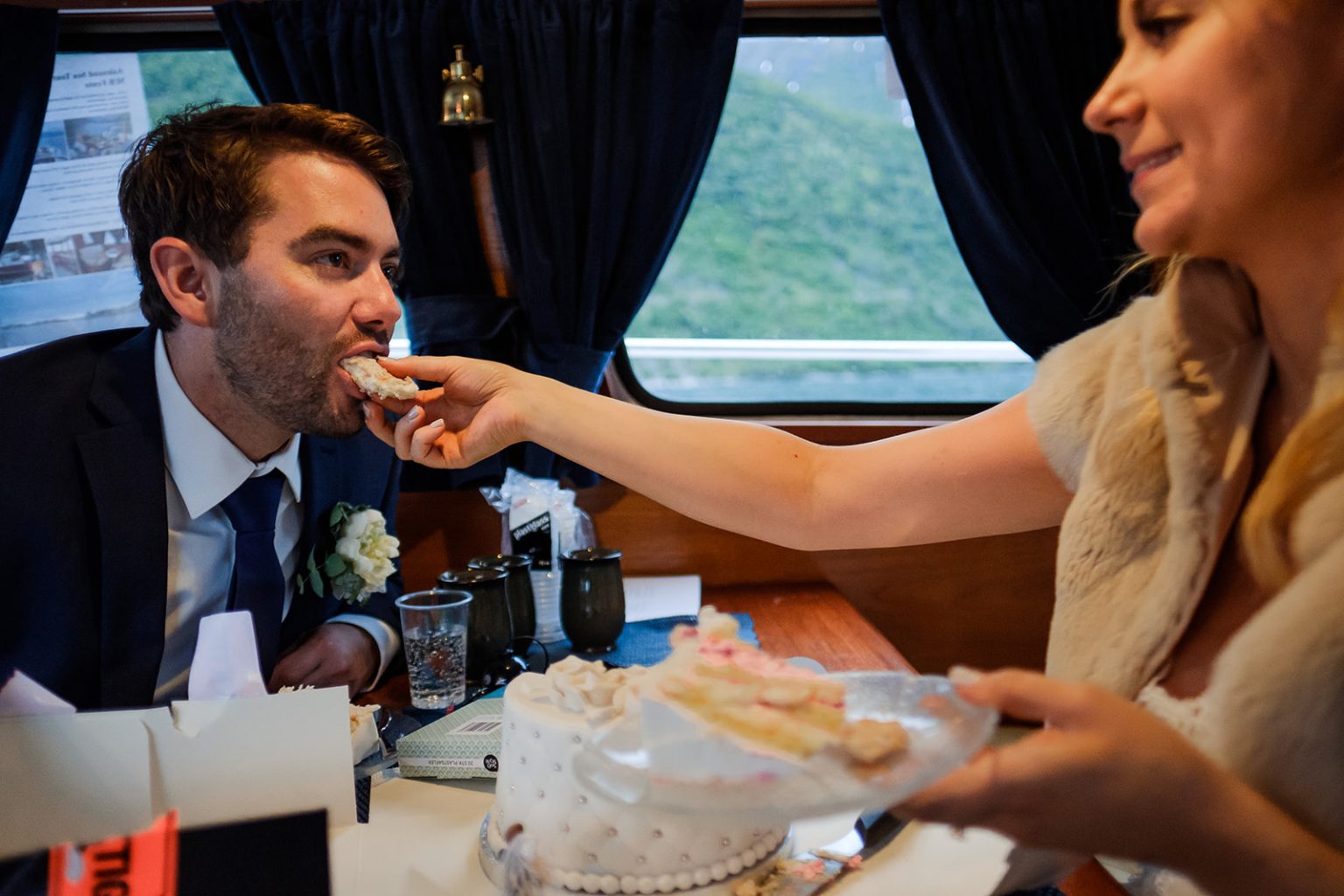 Cutting the cake on the boat, Norway fjord wedding