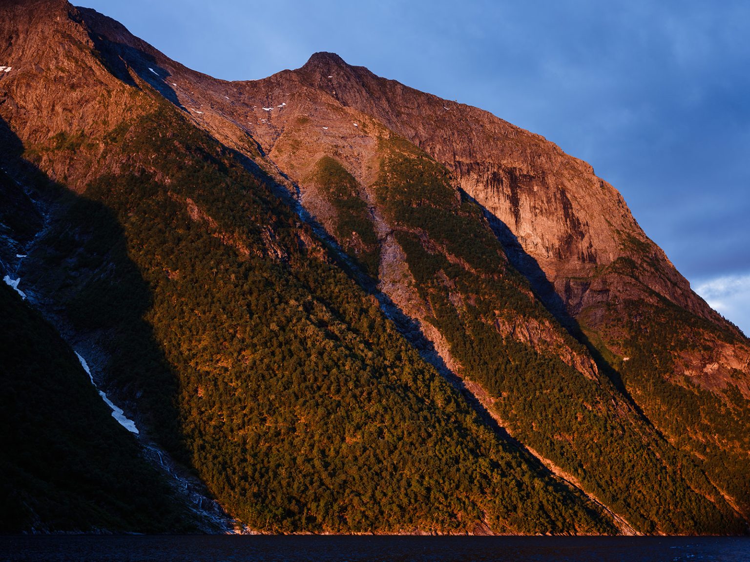 Sunset on the peaks over the Hjørundfjord