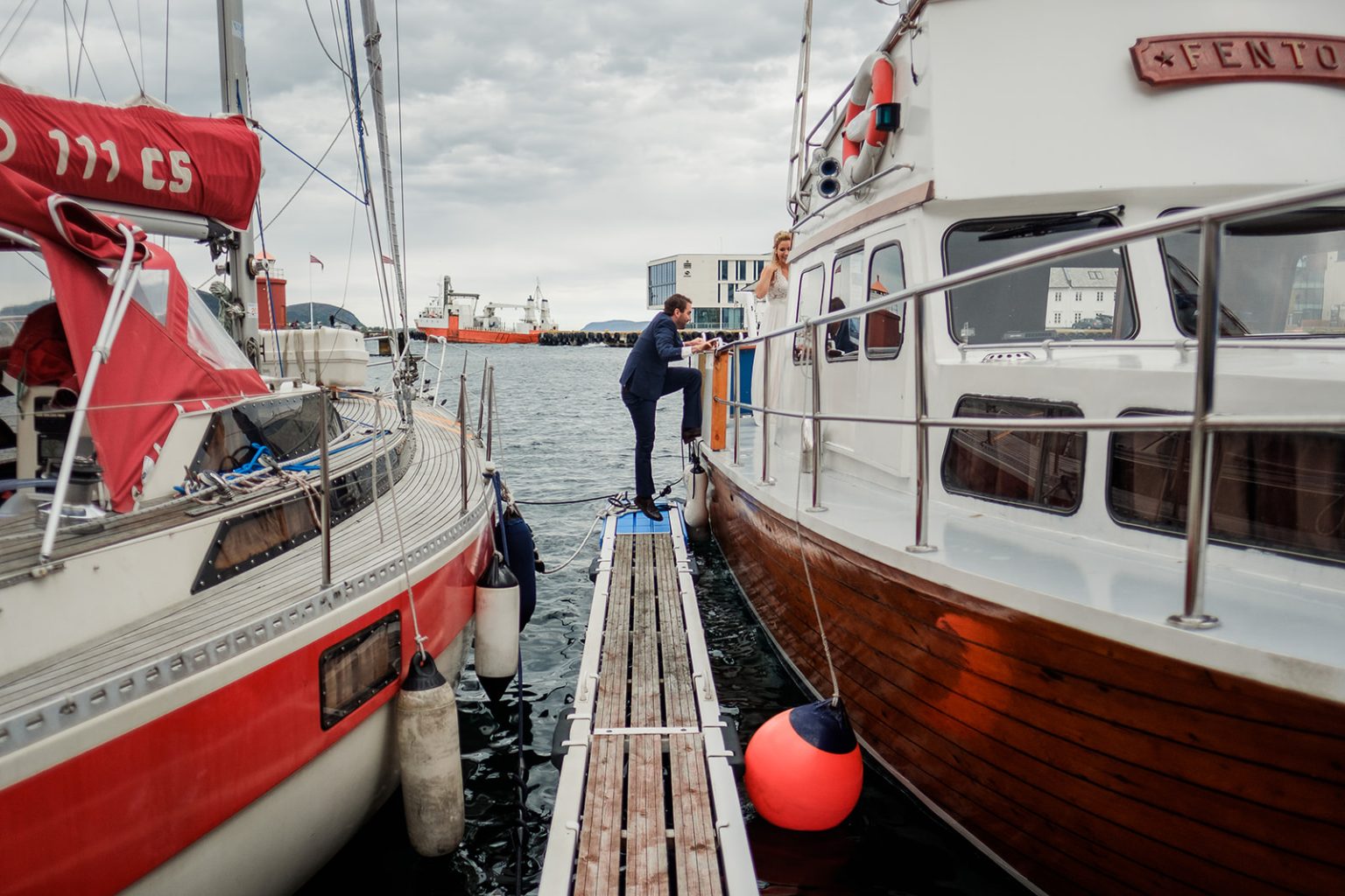 Bride stepping aboard the boat in Ålesund