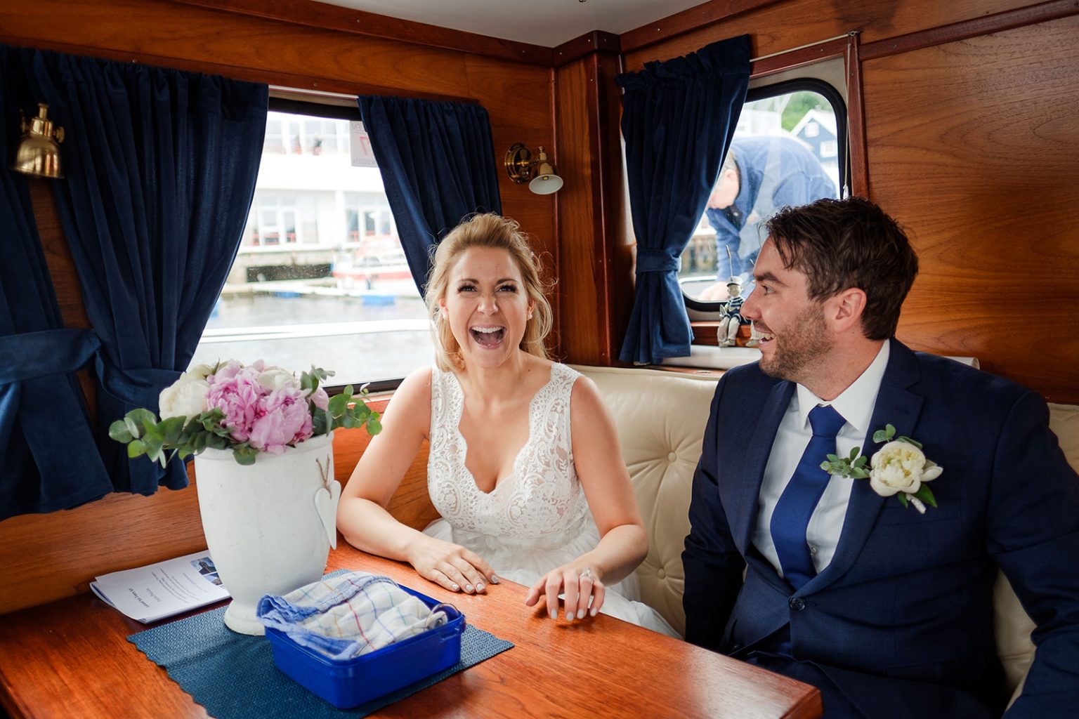 Bride and groom in the cabin of a wooden fjord boat
