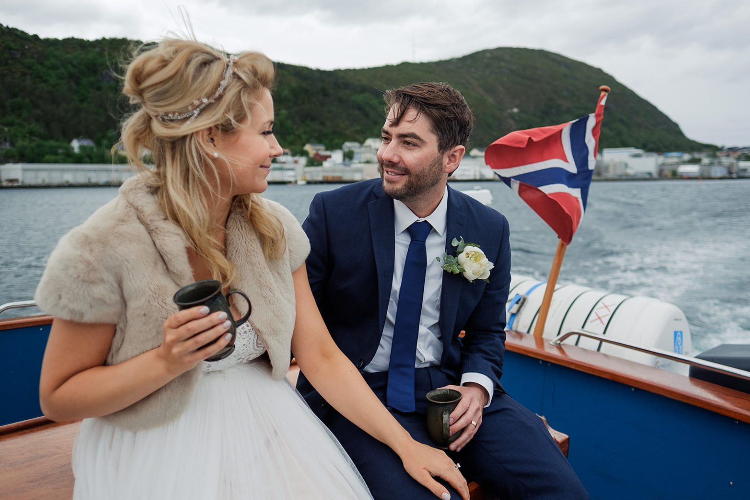 Bride and groom on deck as the boat crosses the fjord