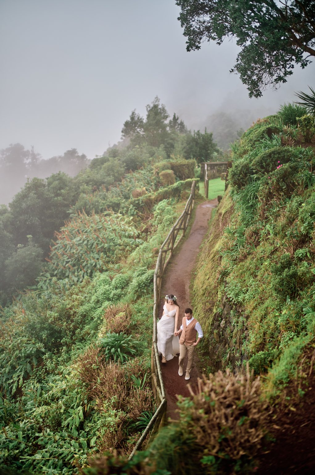 The couple on a terraced miradouro path above the sea, São Miguel