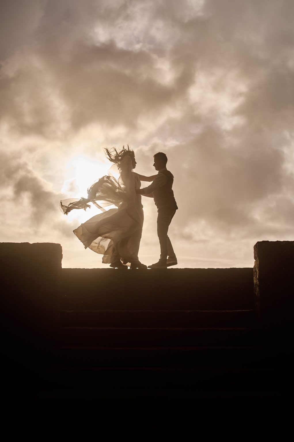 The couple dancing in silhouette against the Azores sunset