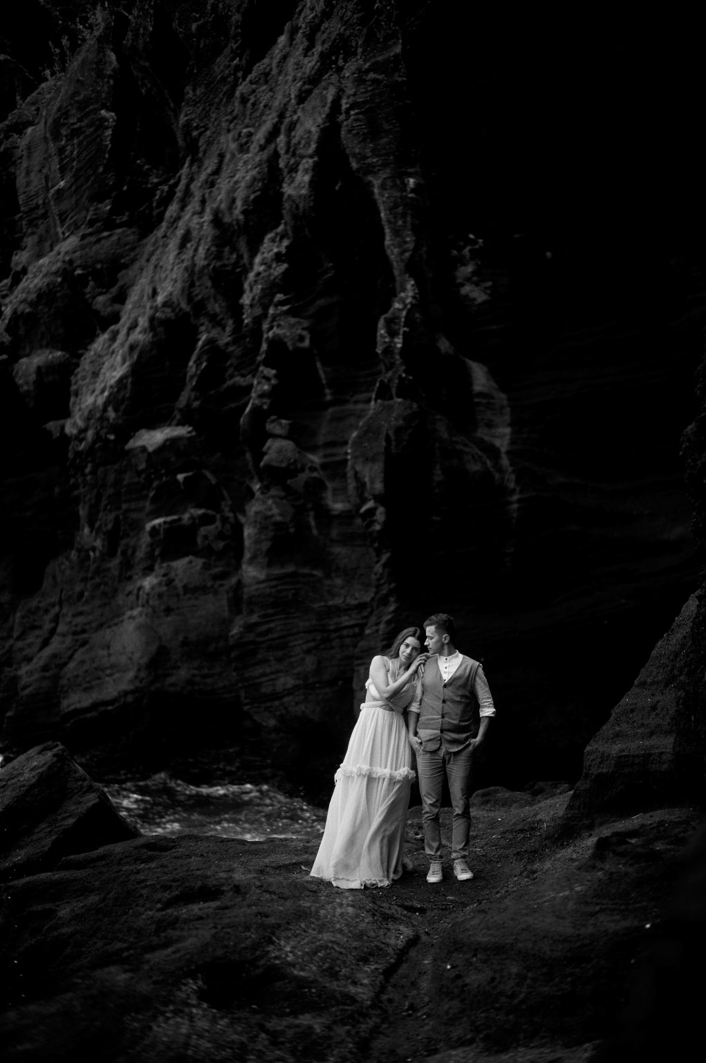 The couple in a dark volcanic cove, São Miguel
