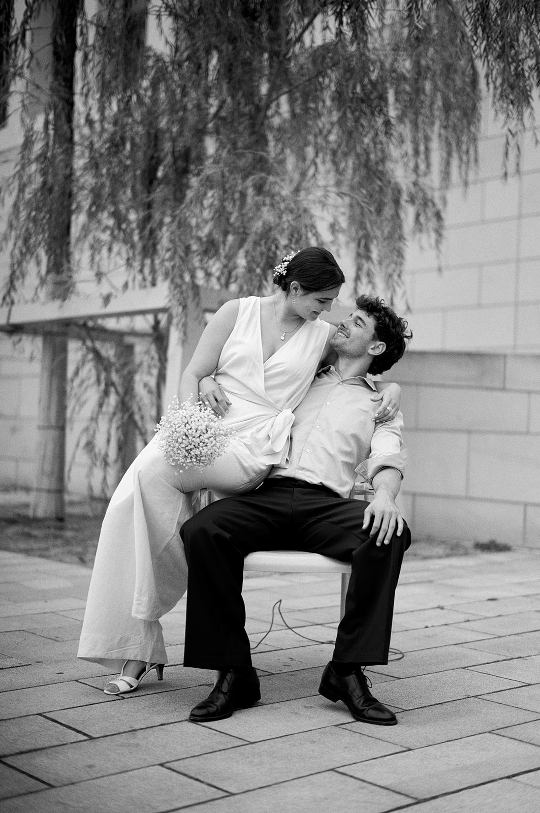 Couple embracing on a chair, black and white Berlin engagement session - Nordica Photography