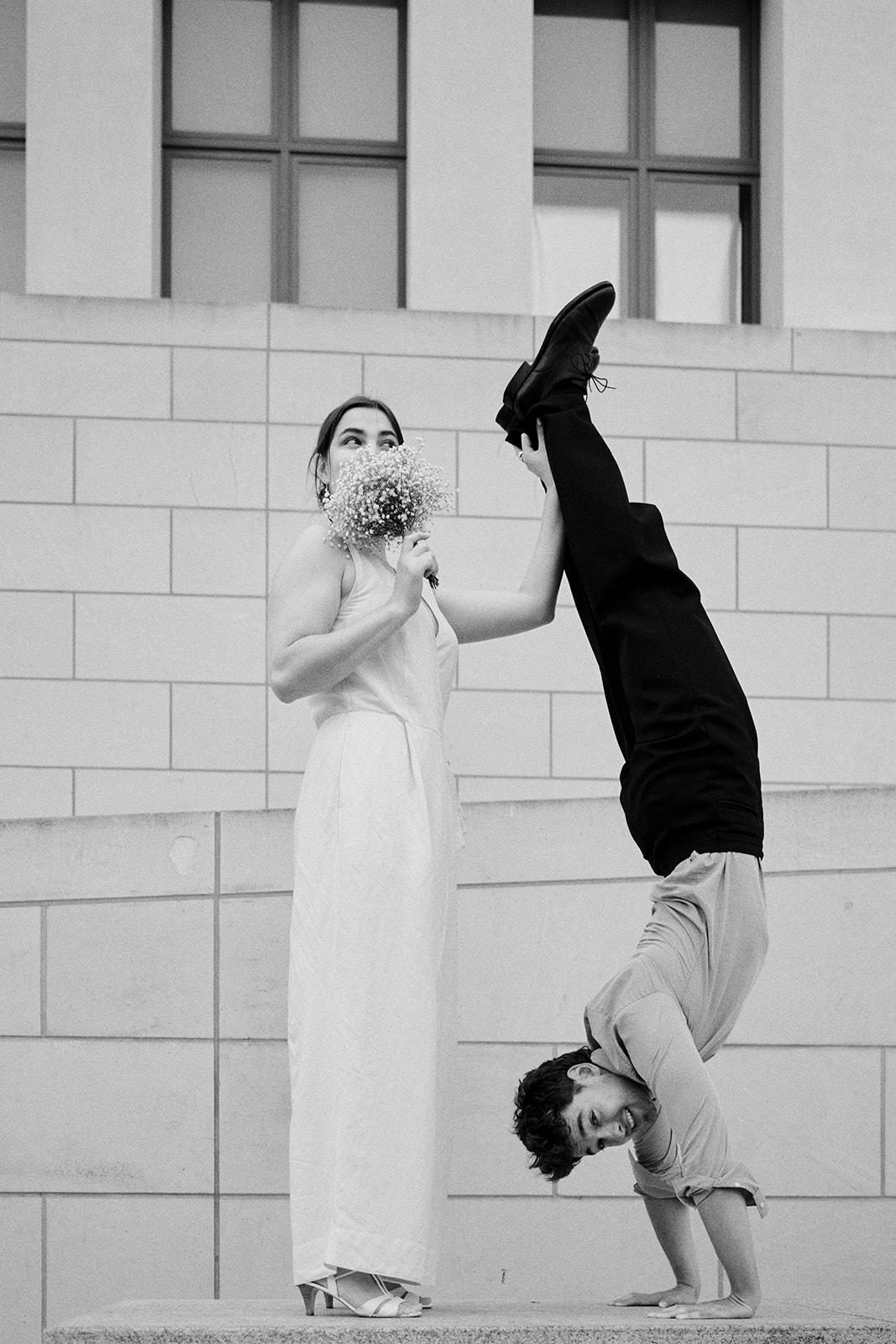 Playful black and white Berlin engagement photo with a bouquet - Nordica Photography
