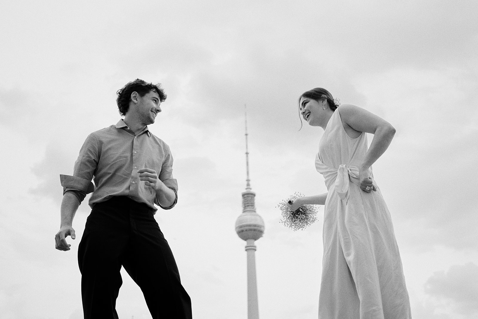 Engaged couple with the Berlin TV Tower between them, black and white - Nordica Photography