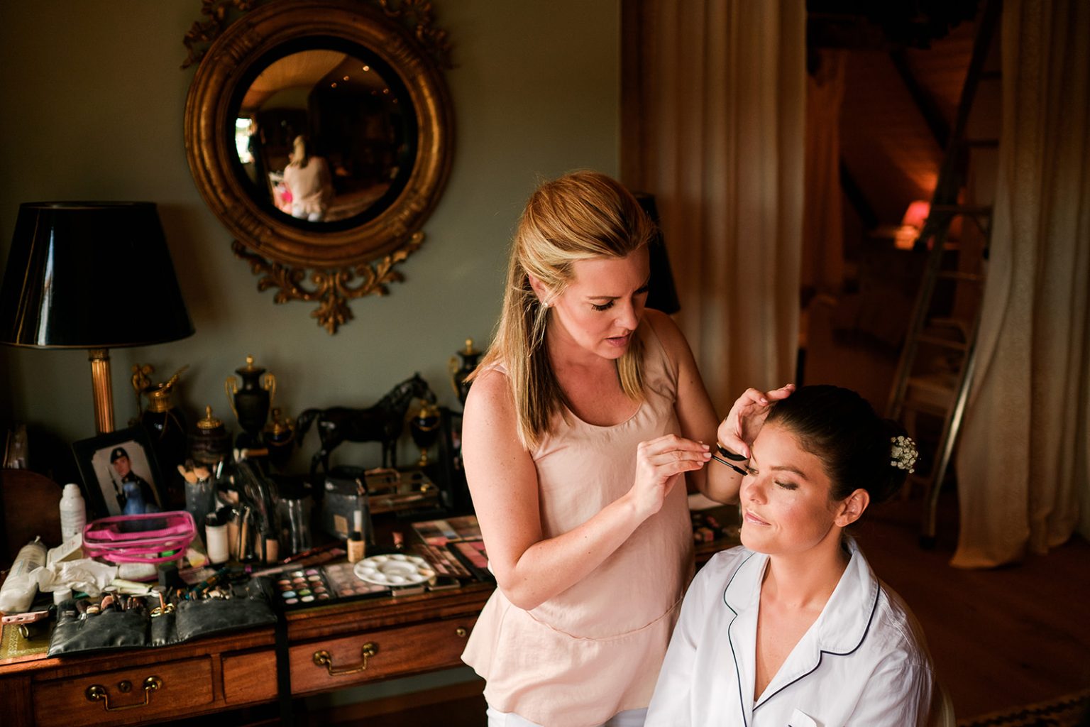 Bride with her bridesmaids getting ready
