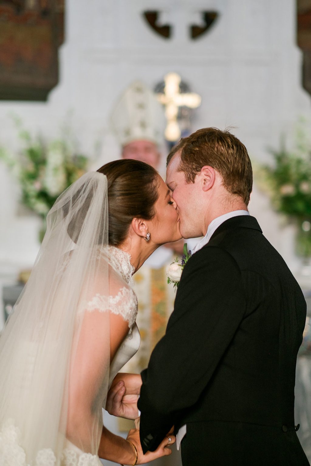 Bride and groom kiss during the ceremony