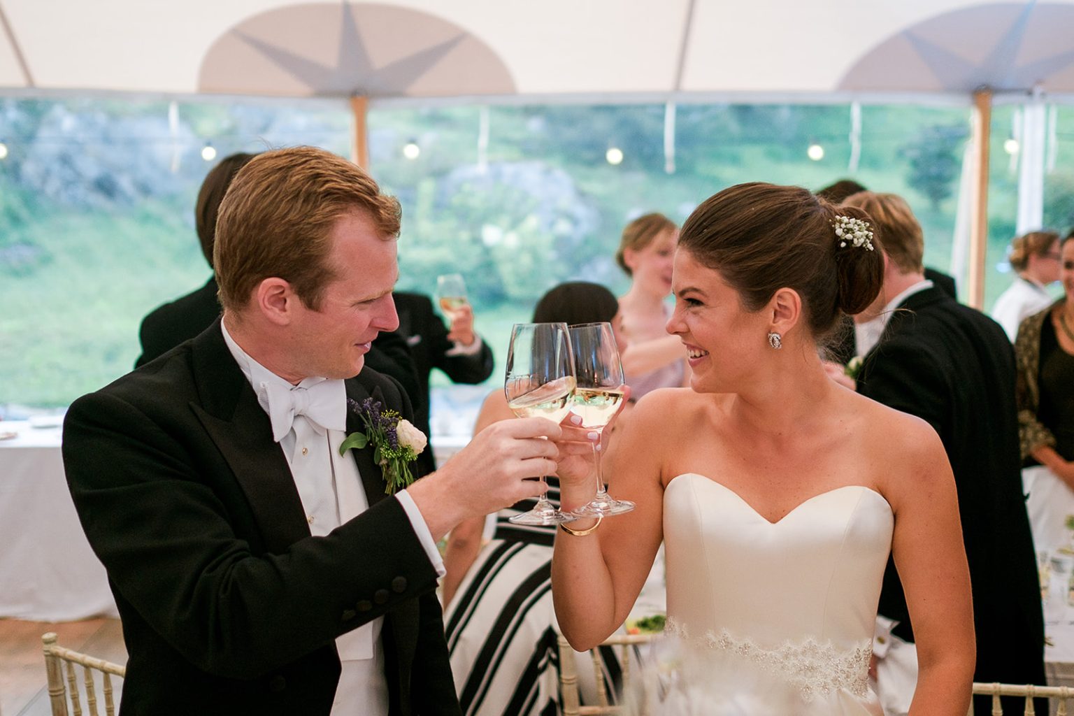 Bride and groom toast during dinner