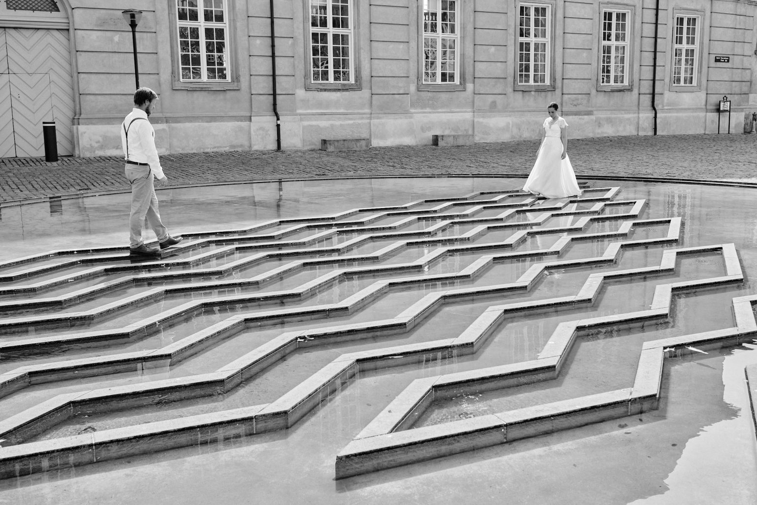 Caroline and Rasmus on a modern stepped plaza in Copenhagen, engagement session