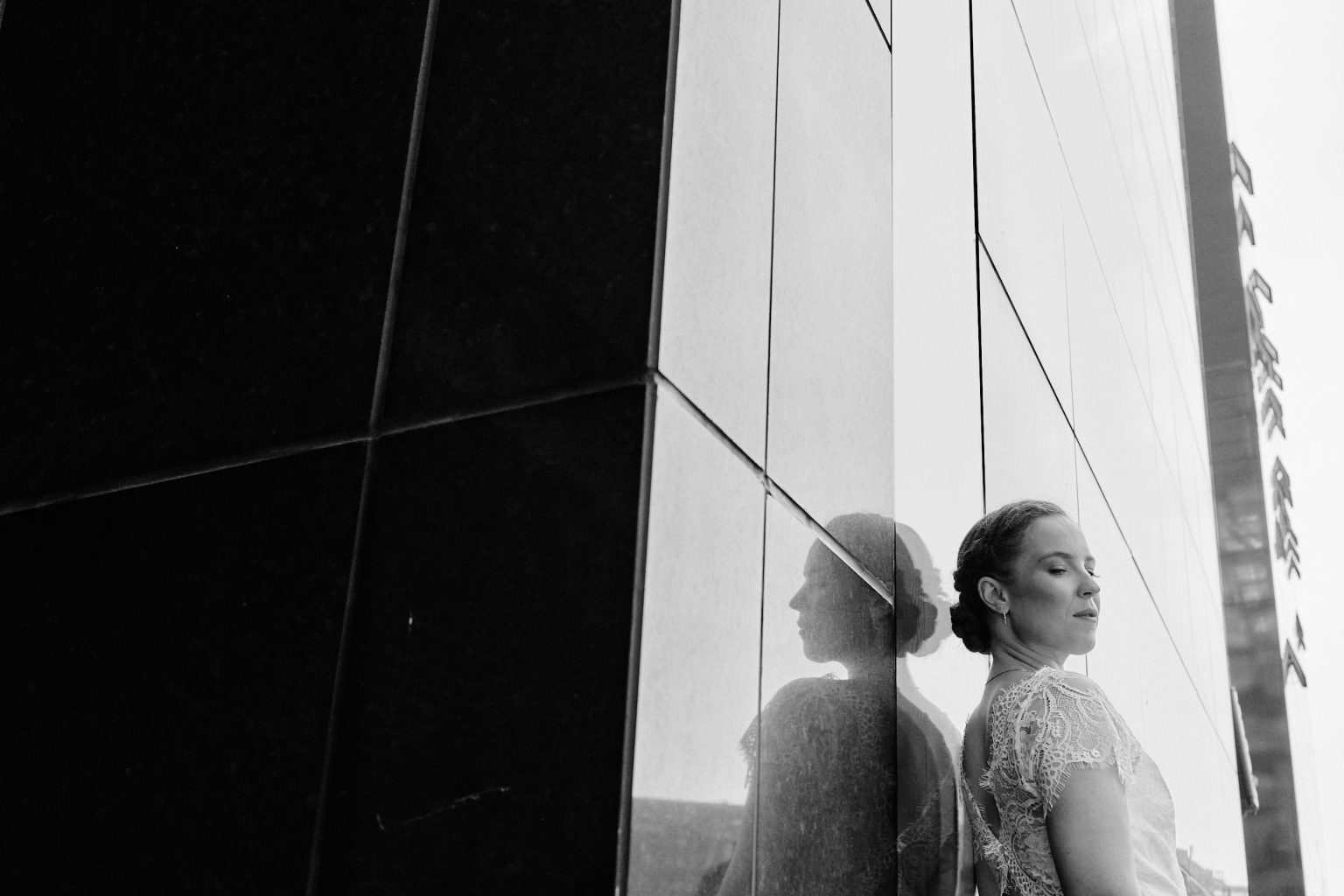 Bride against modern glass architecture on the Copenhagen waterfront, black and white