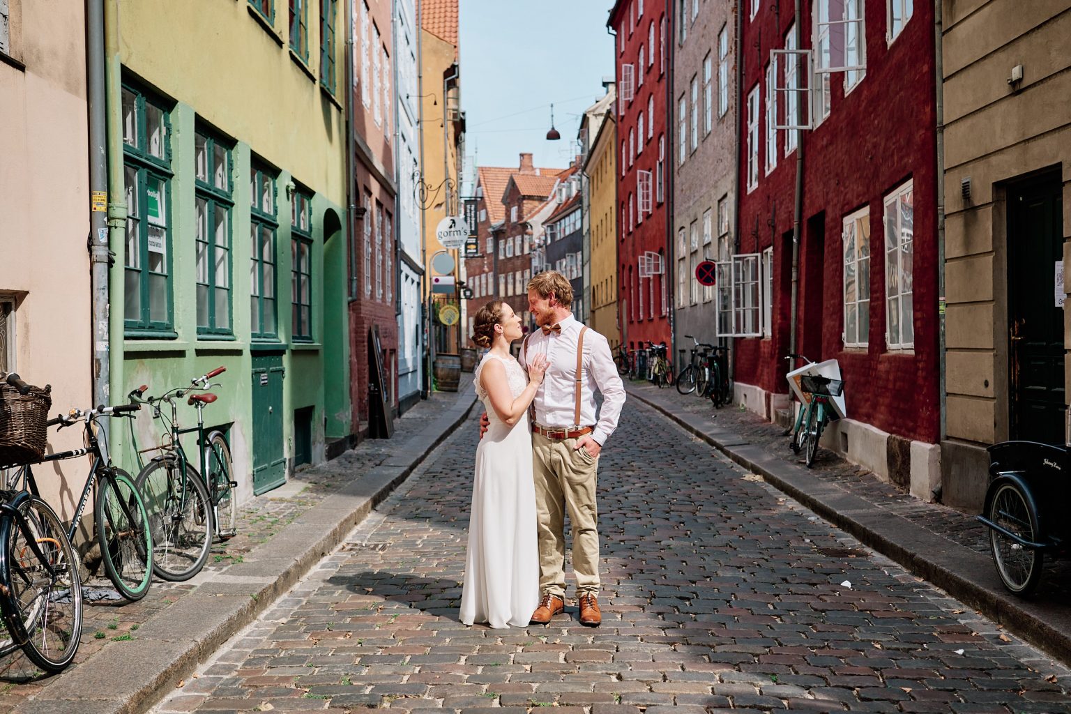 Caroline and Rasmus on a colourful cobbled street in old Copenhagen, engagement session