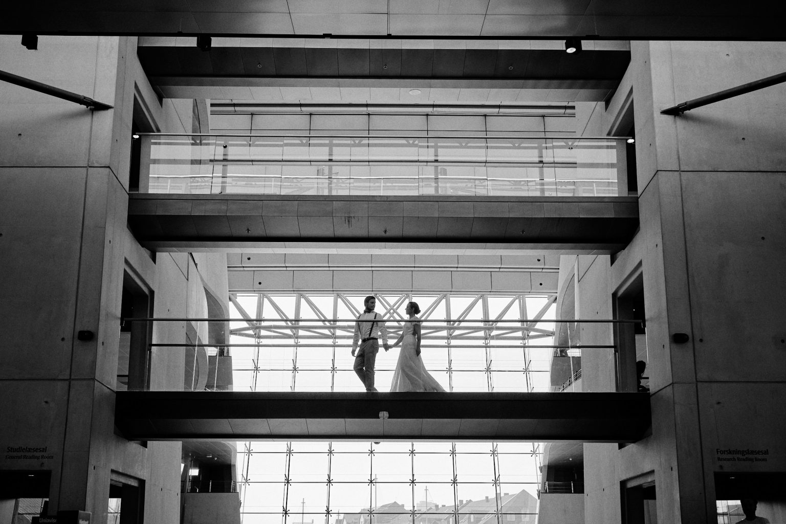 Couple in a modern glass atrium, Copenhagen