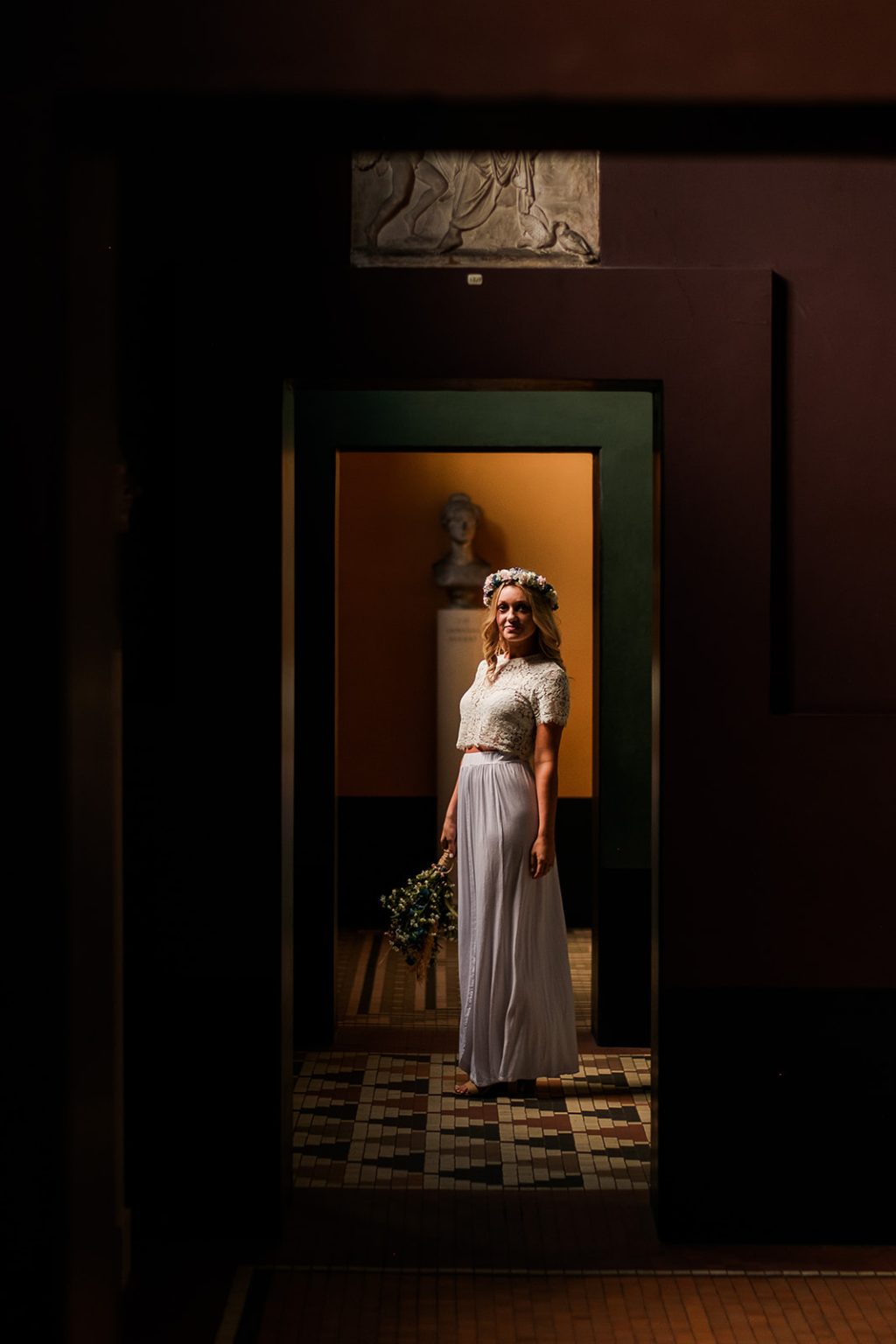 The bride framed in a museum doorway