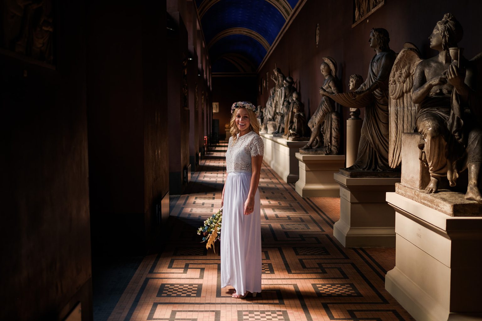 The bride in a sculpture hall at a Copenhagen museum