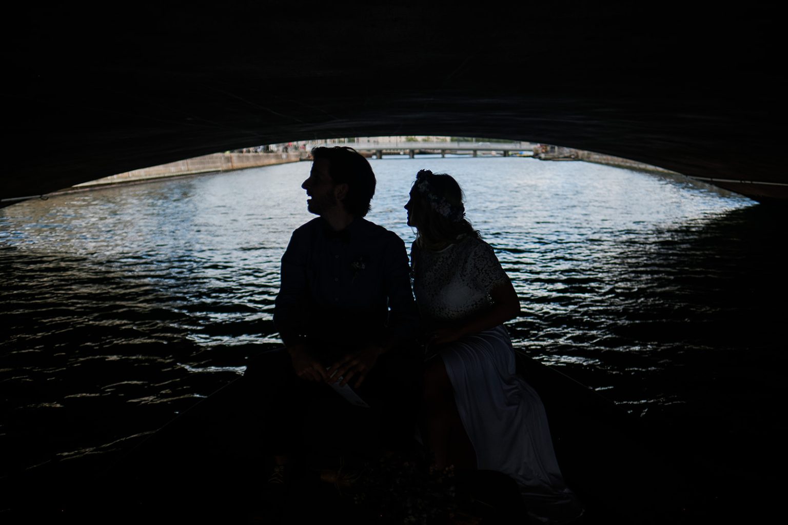 The couple on a canal boat under a bridge in Copenhagen