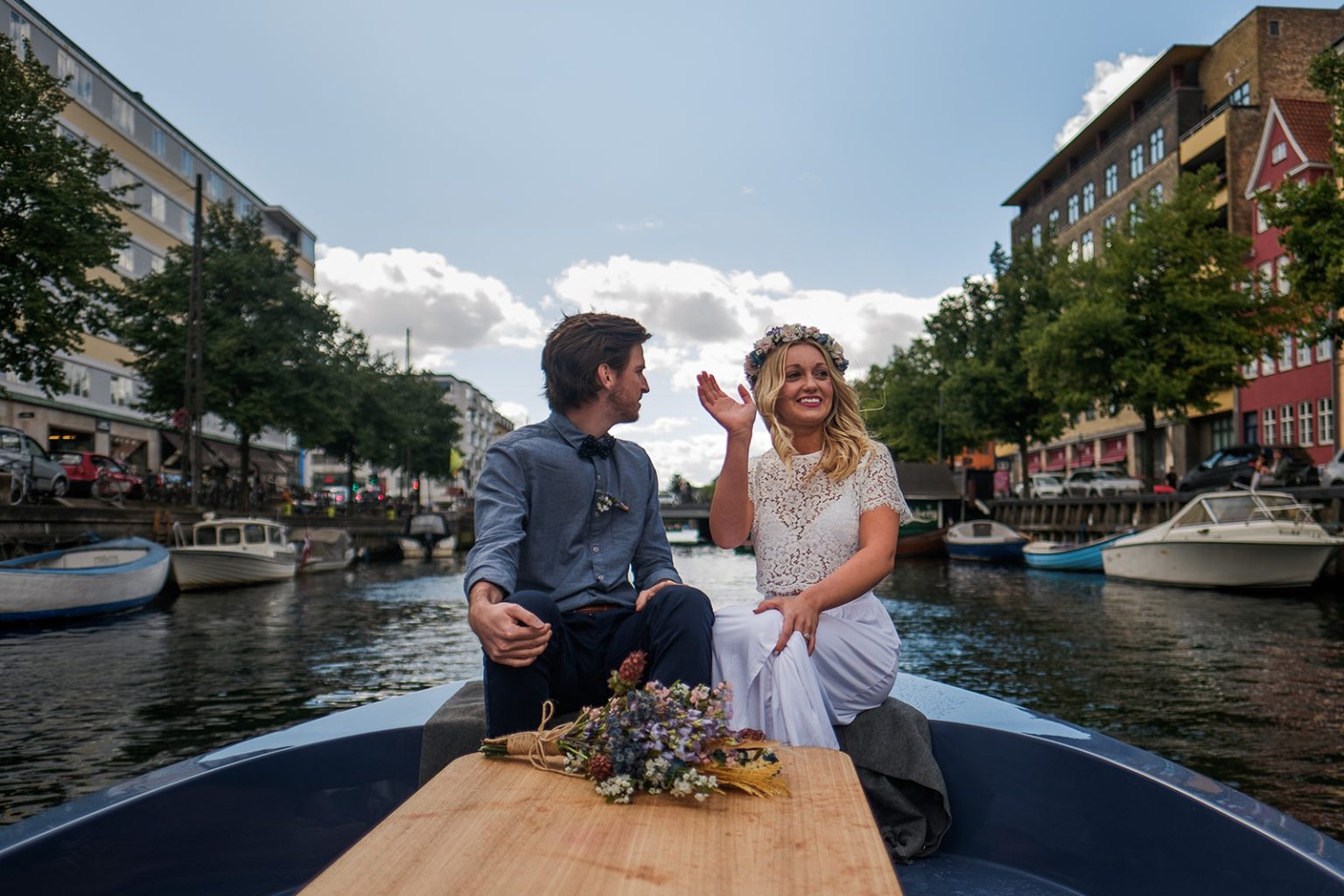 Casey and Jordan driving a boat through the Copenhagen canals