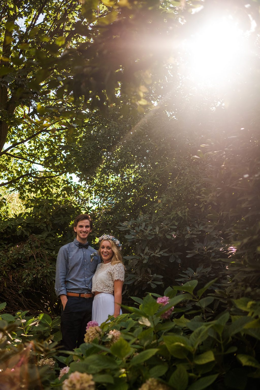 Bride and groom backlit in the Tivoli gardens