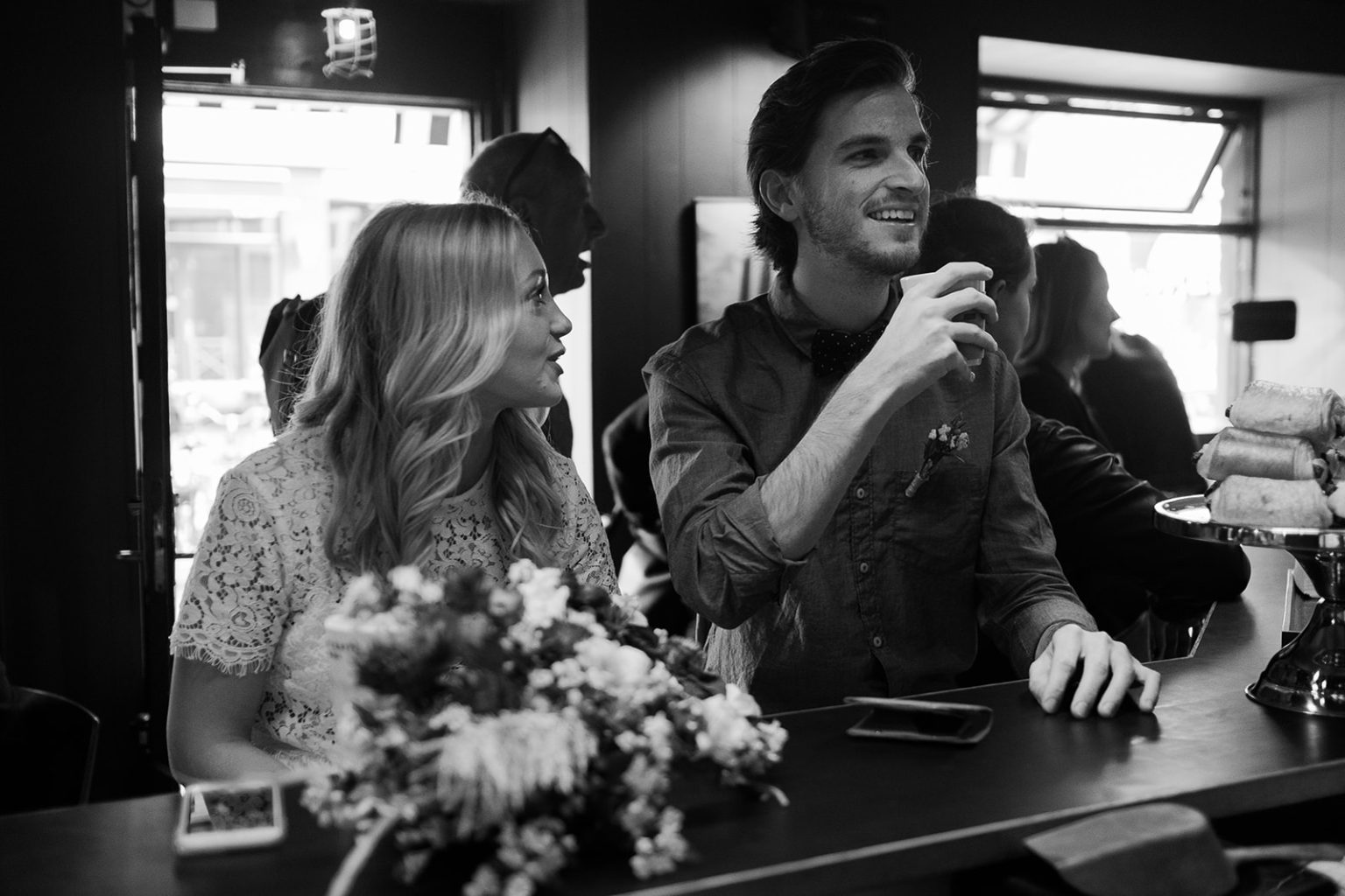 The couple laughing over drinks in a Copenhagen cafe