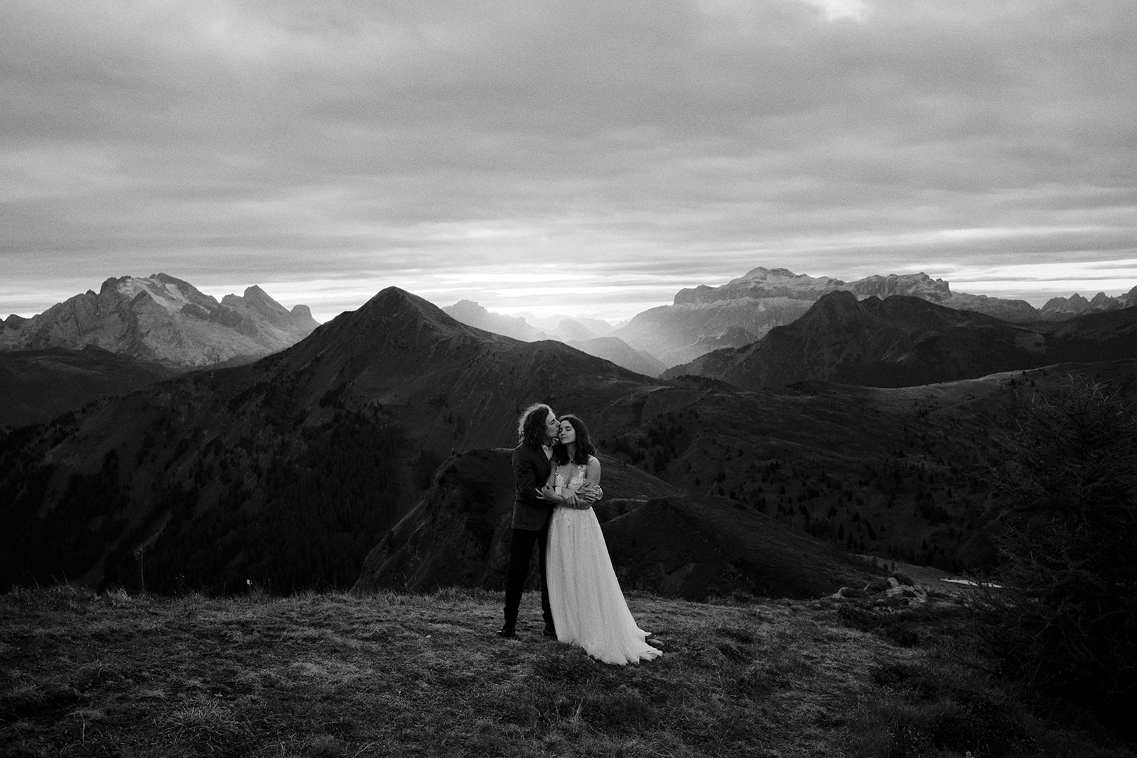 Black and white photograph of a couple in the Dolomites at sunset