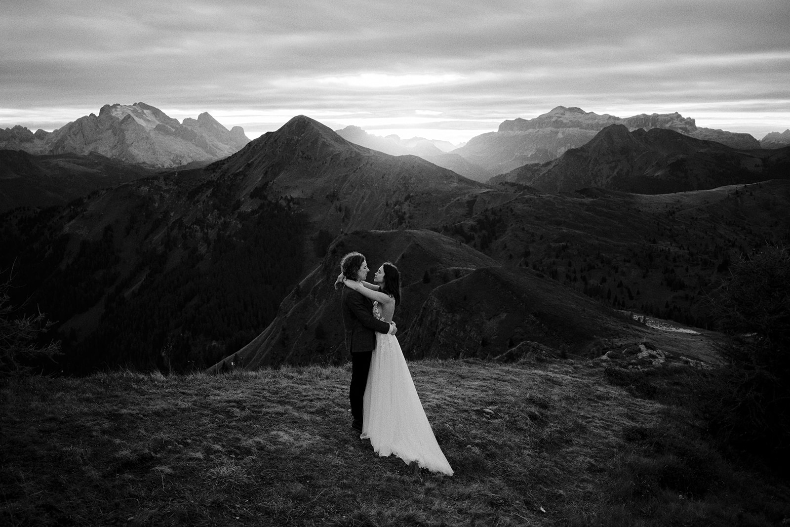 Black and white photograph of a couple in the Dolomites at sunset