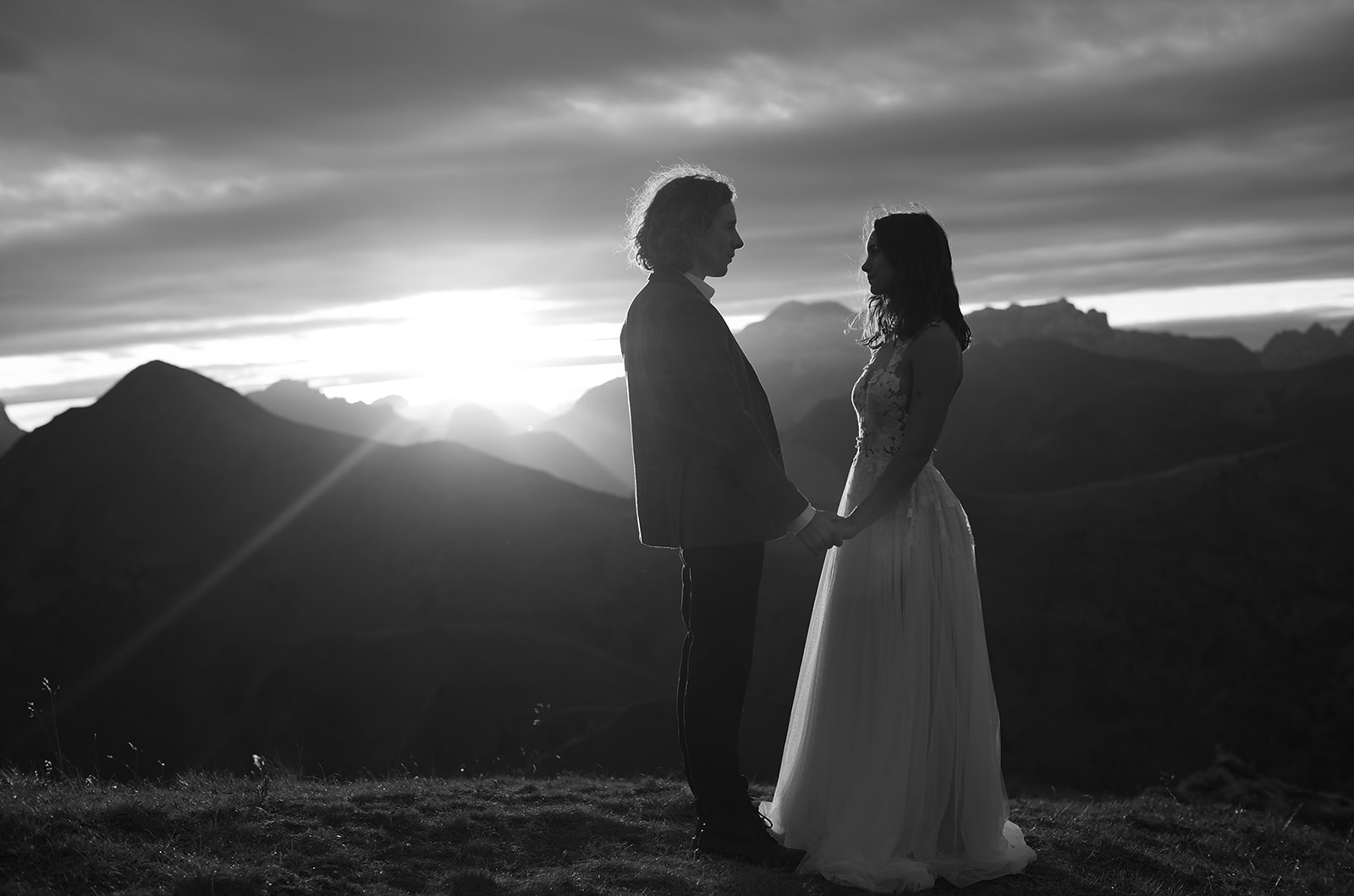 Black and white photograph of a couple in the Dolomites at sunset