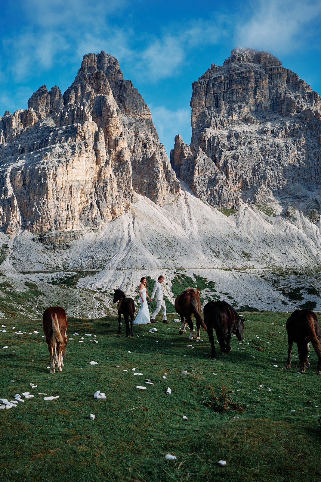 Couple and wild horses in the Dolomites