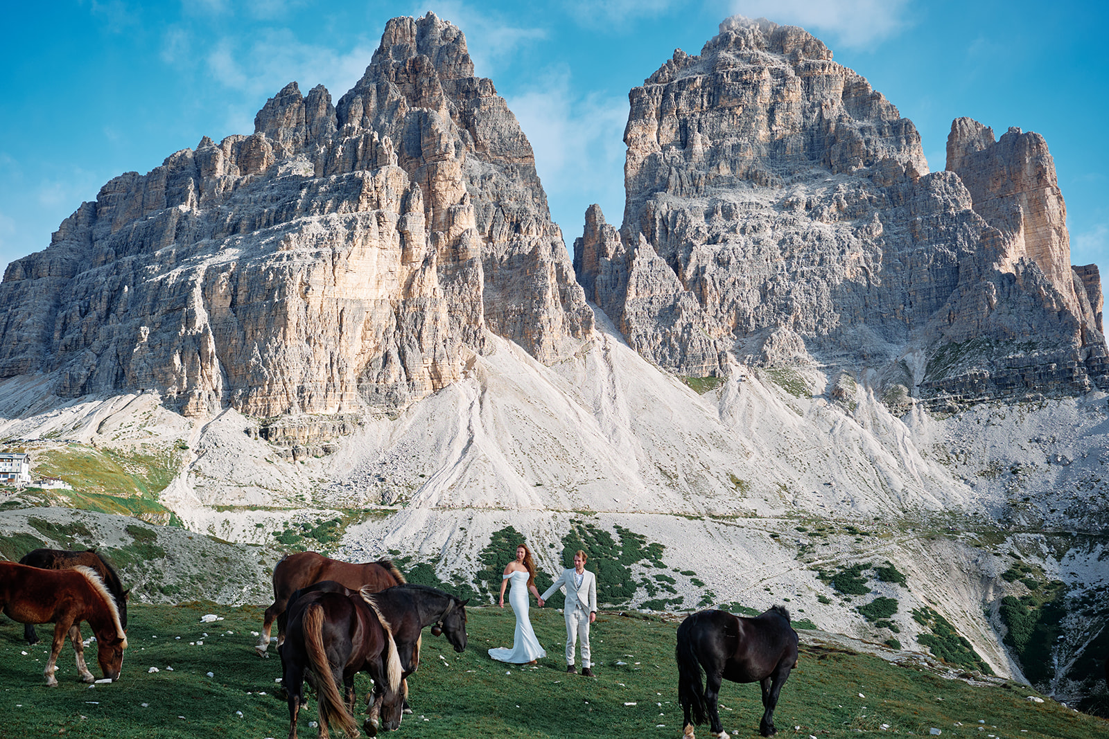 Couple and wild horses in the Dolomites
