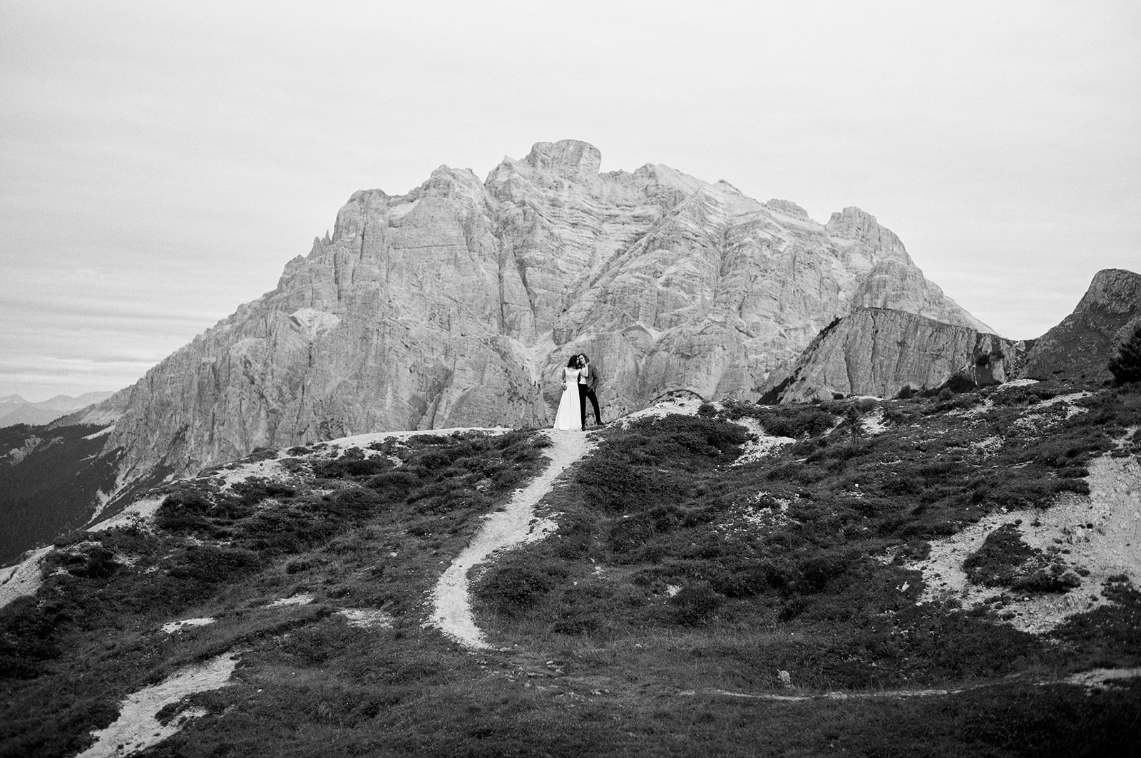 Bride and groom in the meadows above Passo Giau