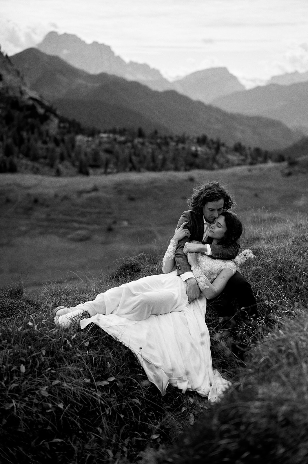 Black and white photograph of a couple in the meadows above Passo Giau