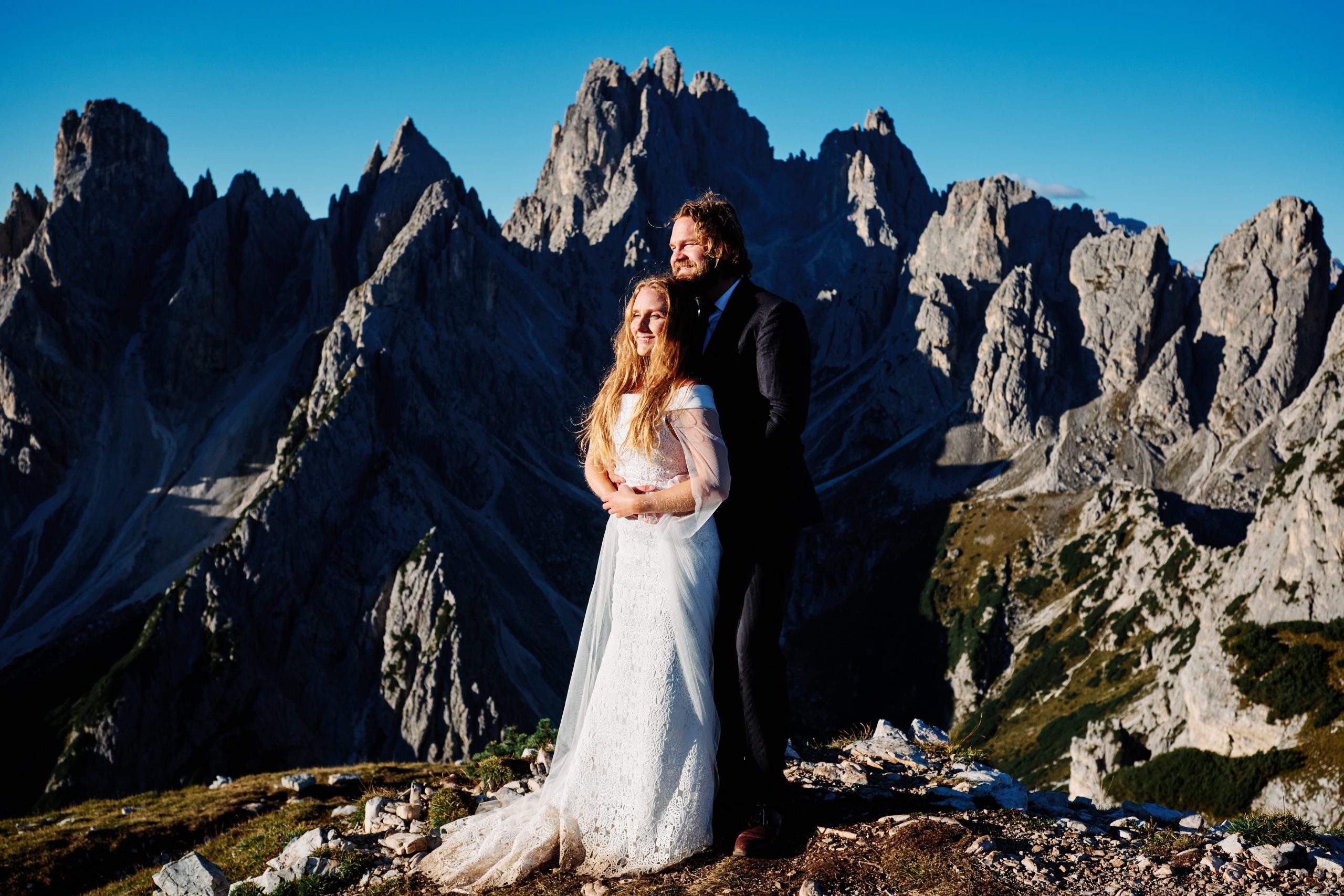 Couple on a ledge above the Cadini spires, Dolomites