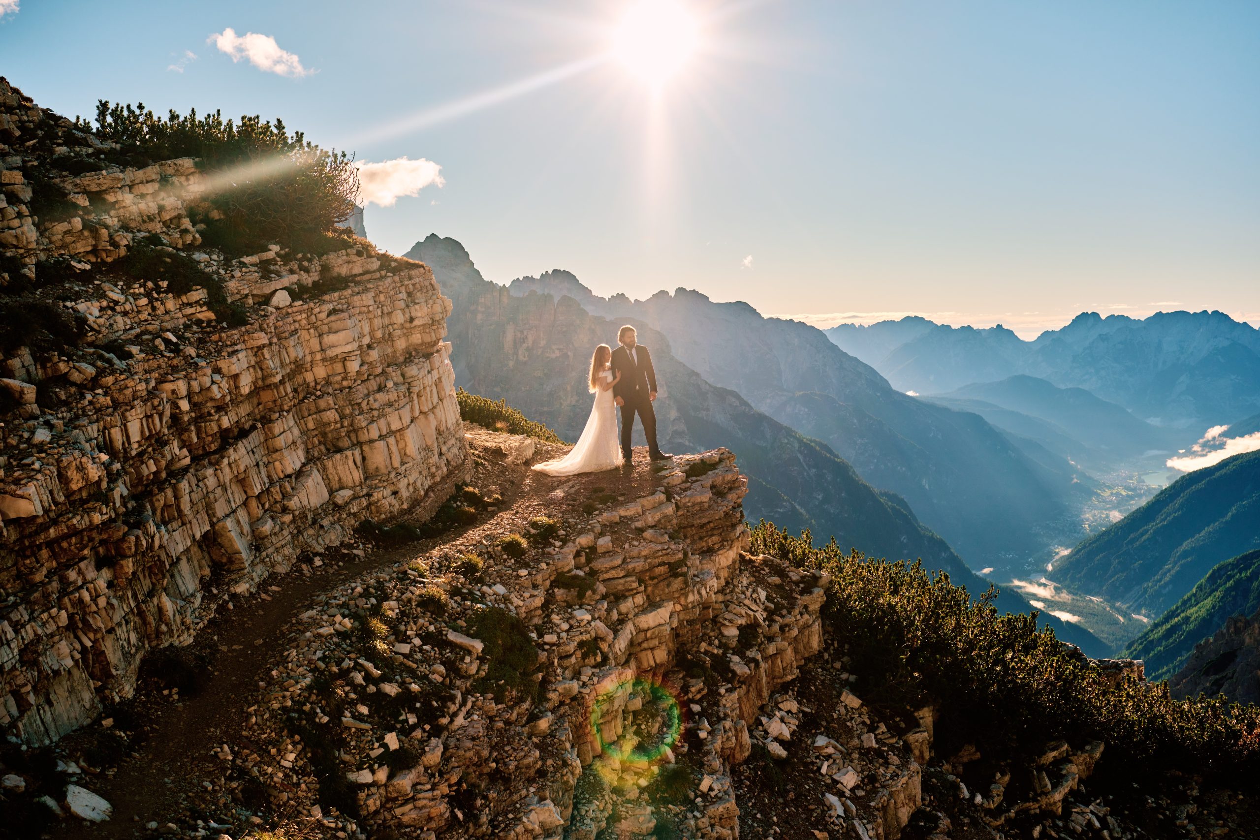 Bride on a rocky ledge, backlit, Dolomites