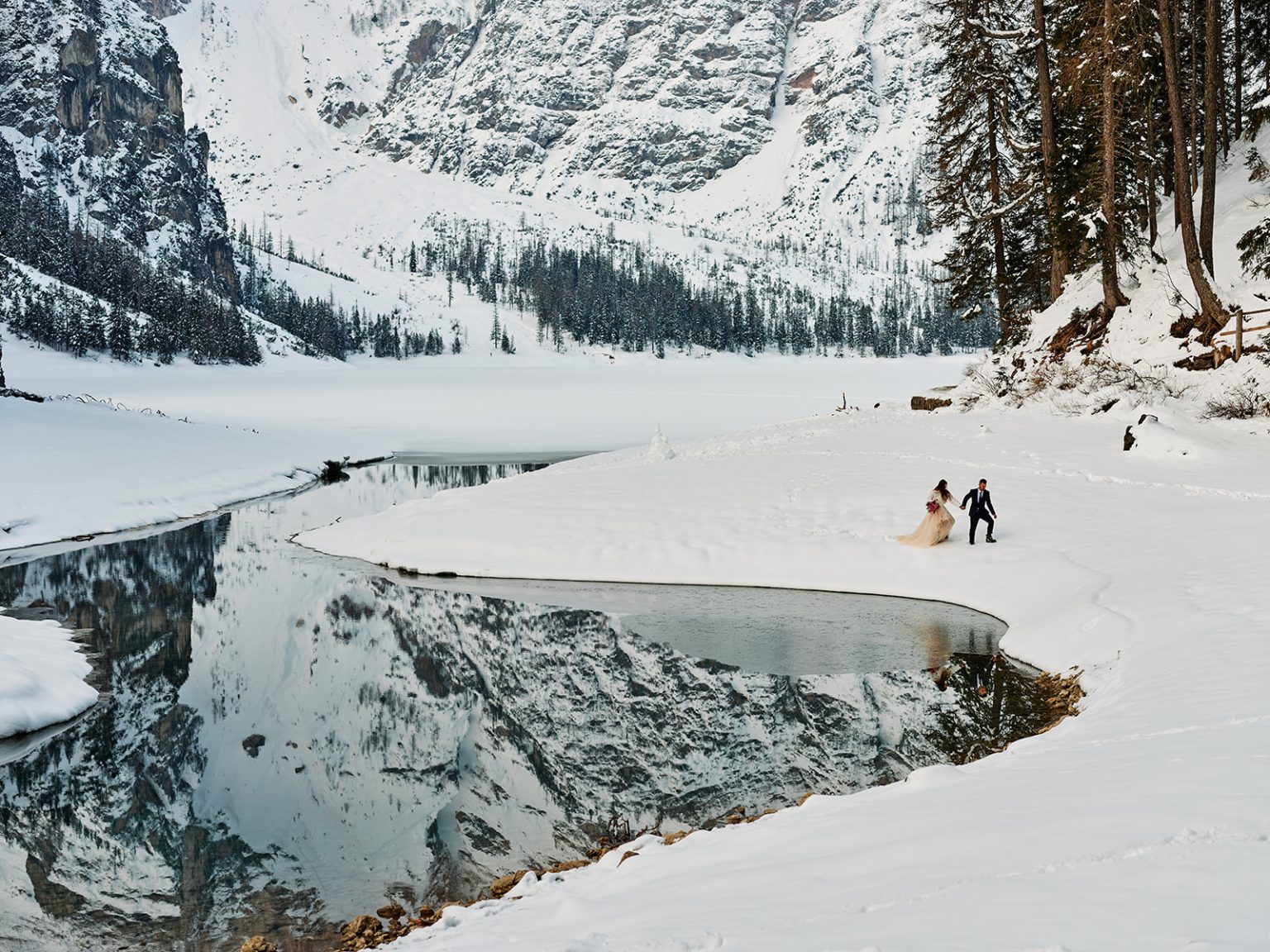 The frozen lake and snowy peaks at Lago di Braies, Dolomites, Italy