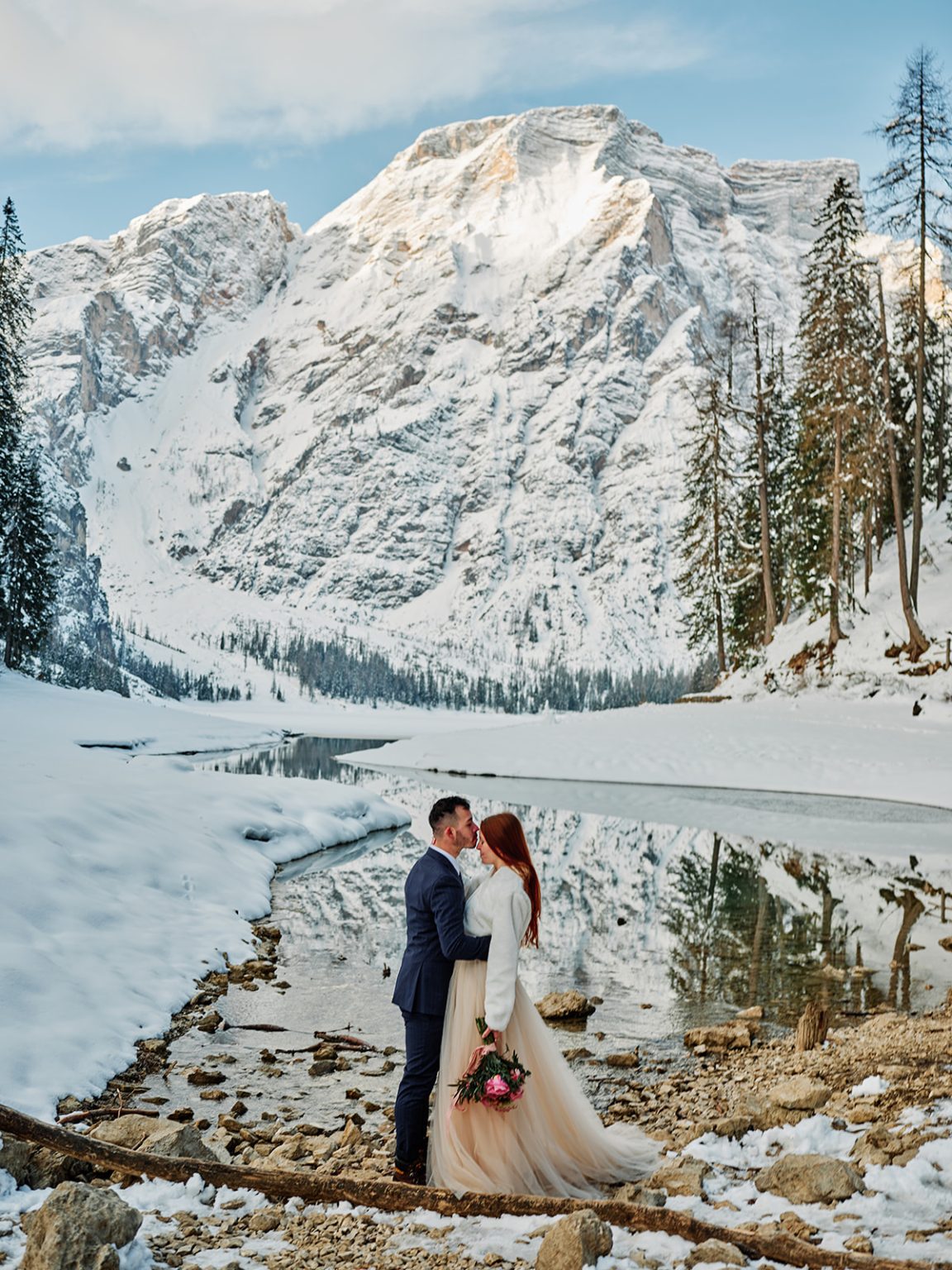 Kristina and Cristian embracing on the frozen lakeshore, Lago di Braies