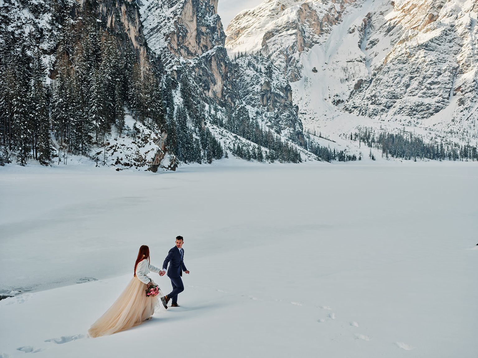 Kristina walking the snow in her dress, Lago di Braies, Dolomites